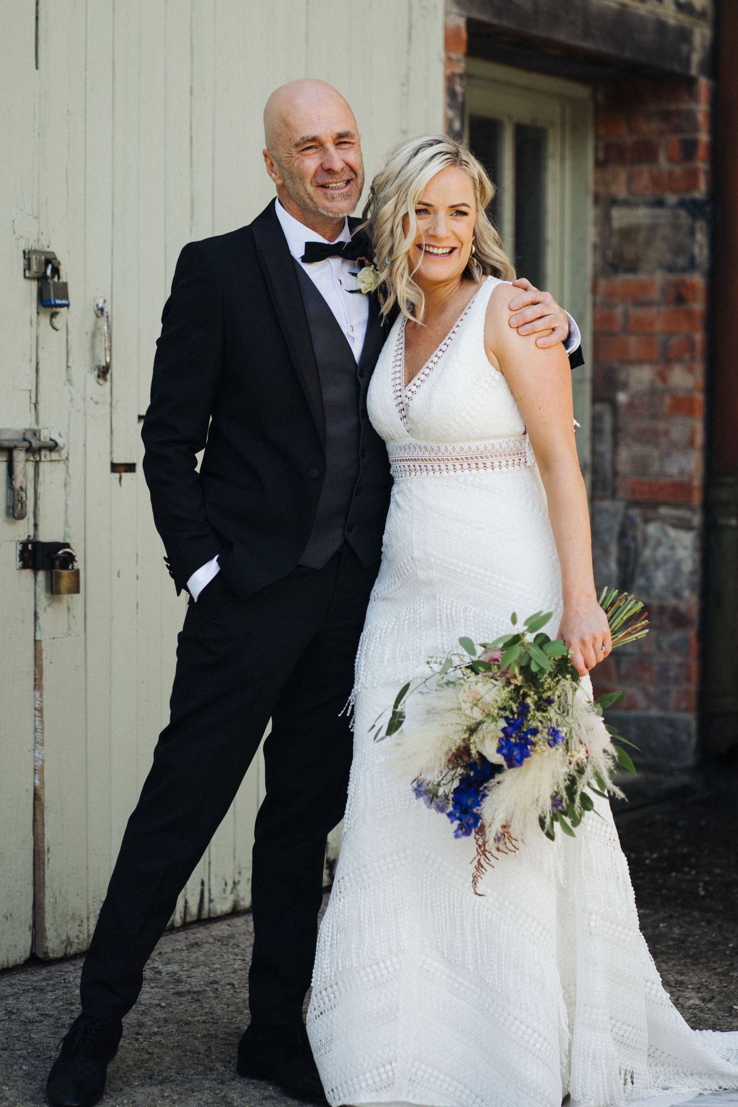 A bride and groom share candid moments together in three wedding photos against a rustic brick wall backdrop.
