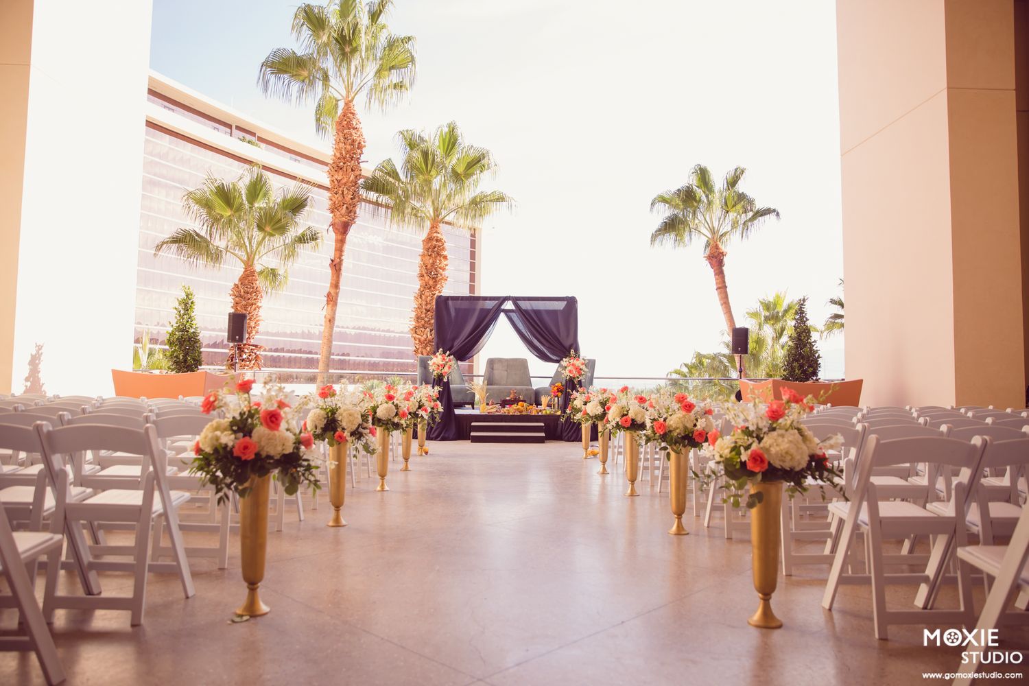 Black and white wedding photos showing a bride in a flowing white dress with a long veil in an elegant hallway setting.