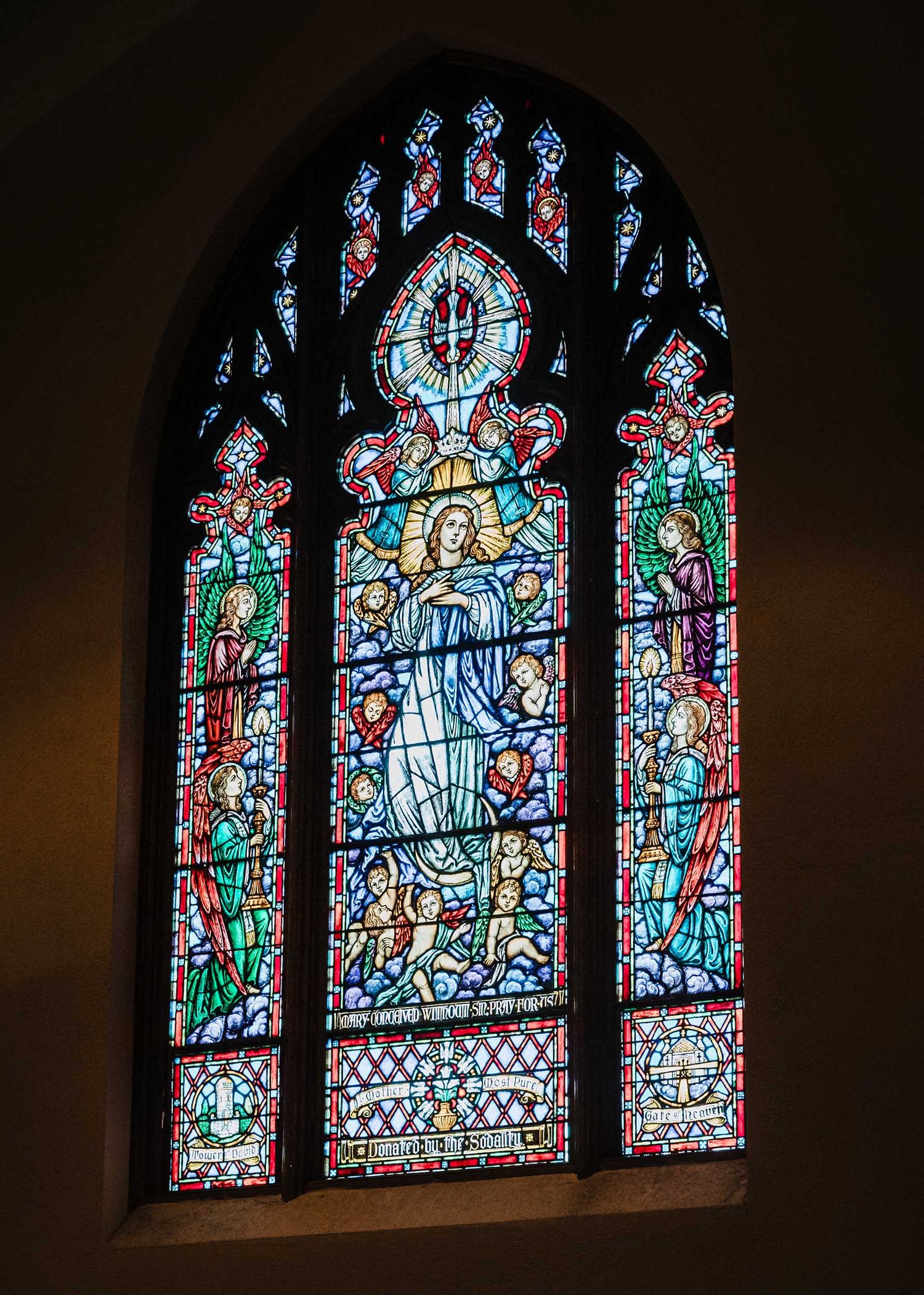 Church altar with stained glass window inside Saint Brigid Church in South Boston before a wedding ceremony