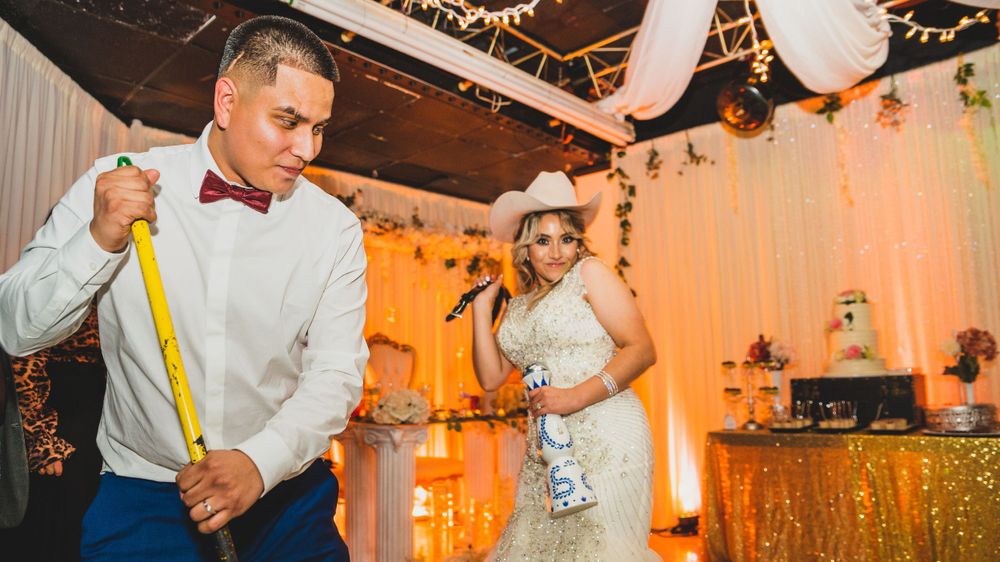 People dancing at a wedding reception with lively Mexican traditions, captured by Albany Capture - Chicago wedding photographers.