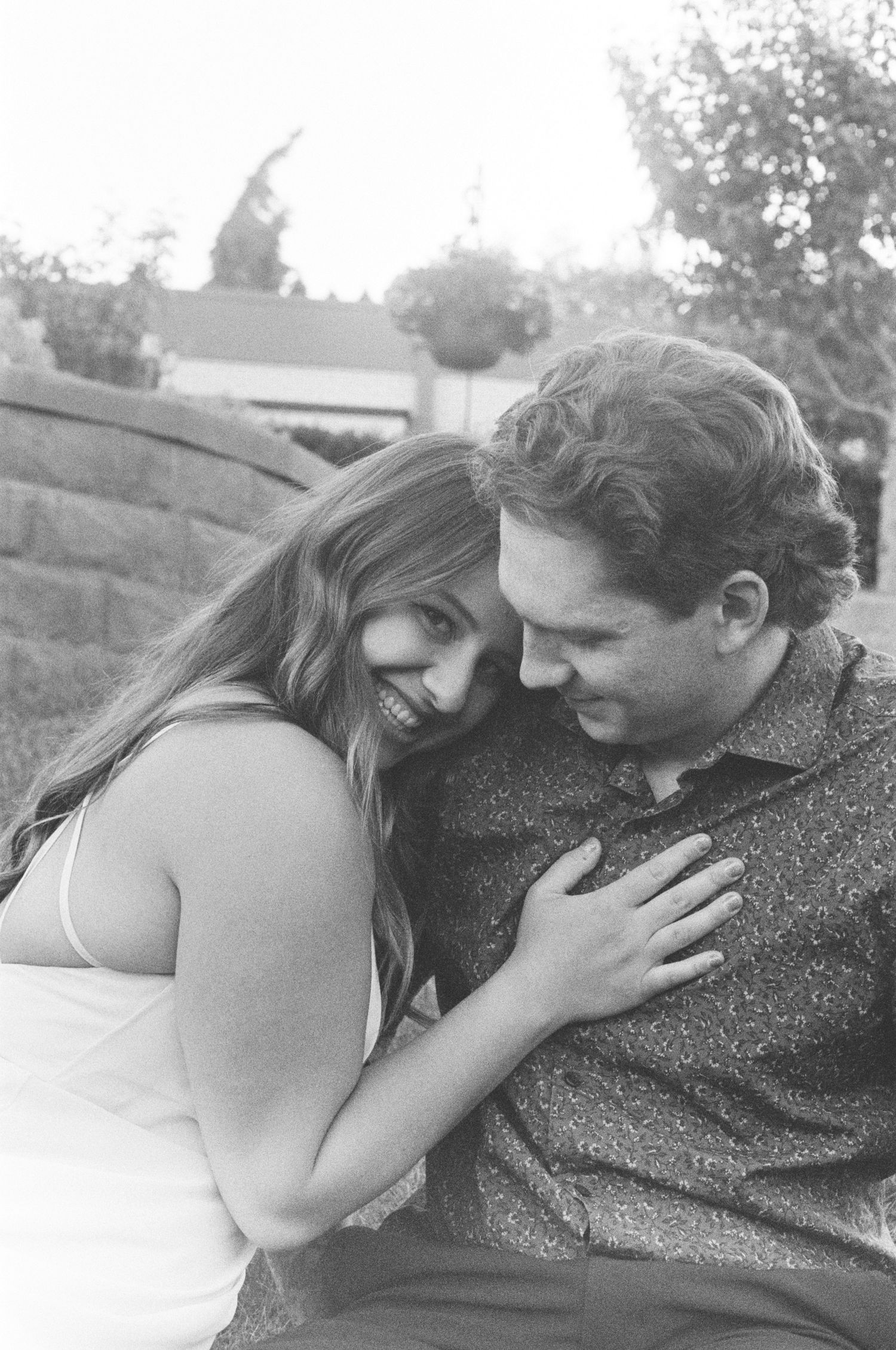 A romantic black and white photograph of a tender embrace between two people.