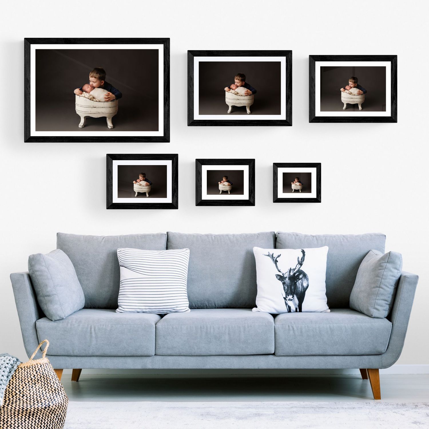 A cozy living room featuring a couch, a chair, and a wall adorned with various pictures.