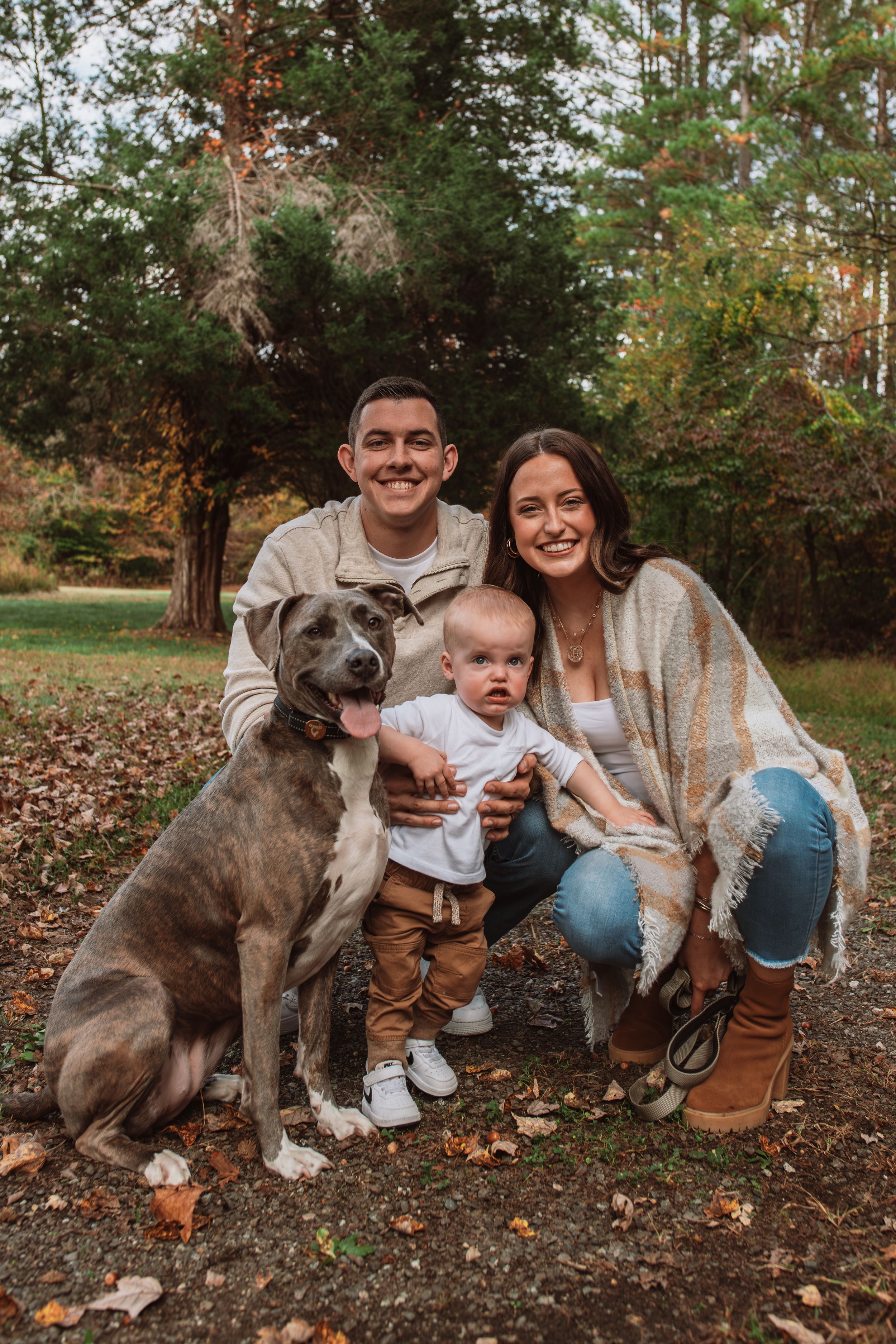 Family with dog in park for family photoshoot captured by Maryland family photographer Mallory Bramlett.