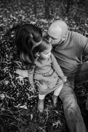 Mother and Father kissing toddler for family session captured by Maryland family photographer Mallory Bramlett.