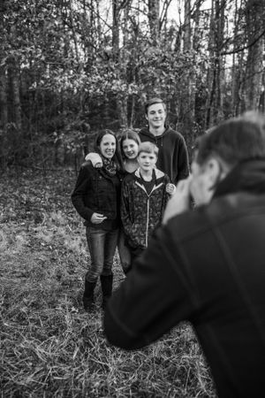Dad pretending to take pictures of his family for family photography session captured by Maryland family photographer Mallory Bramlett.