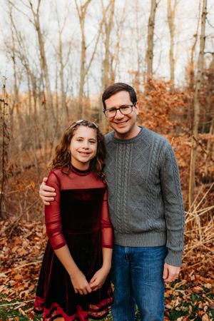 Father and daughter in backyard for in home family photoshoot captured by Maryland family photographer Mallory Bramlett.