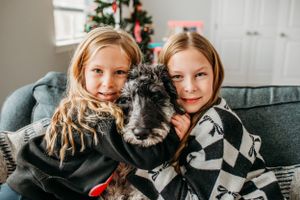 Children with their dog for in home family photoshoot captured by Maryland family photographer Mallory Bramlett.