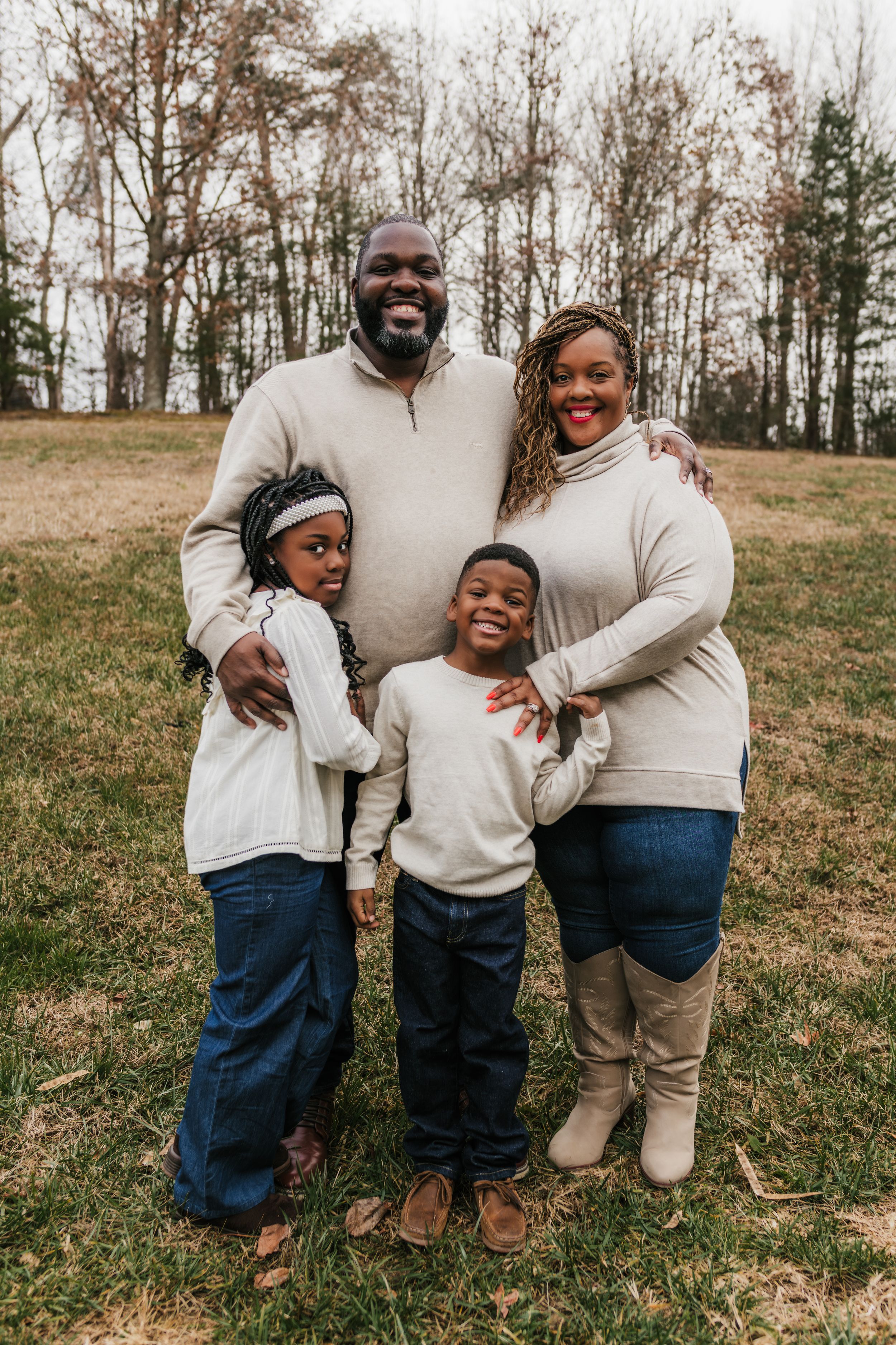 Family posing in their backyard for in home family photography photoshoot captured by Maryland family photographer Mallory Bramlett.