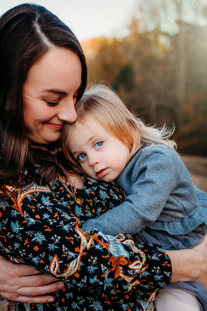 Mother with child on lap for motherhood photography session captured by Maryland family photographer Mallory Bramlett.
