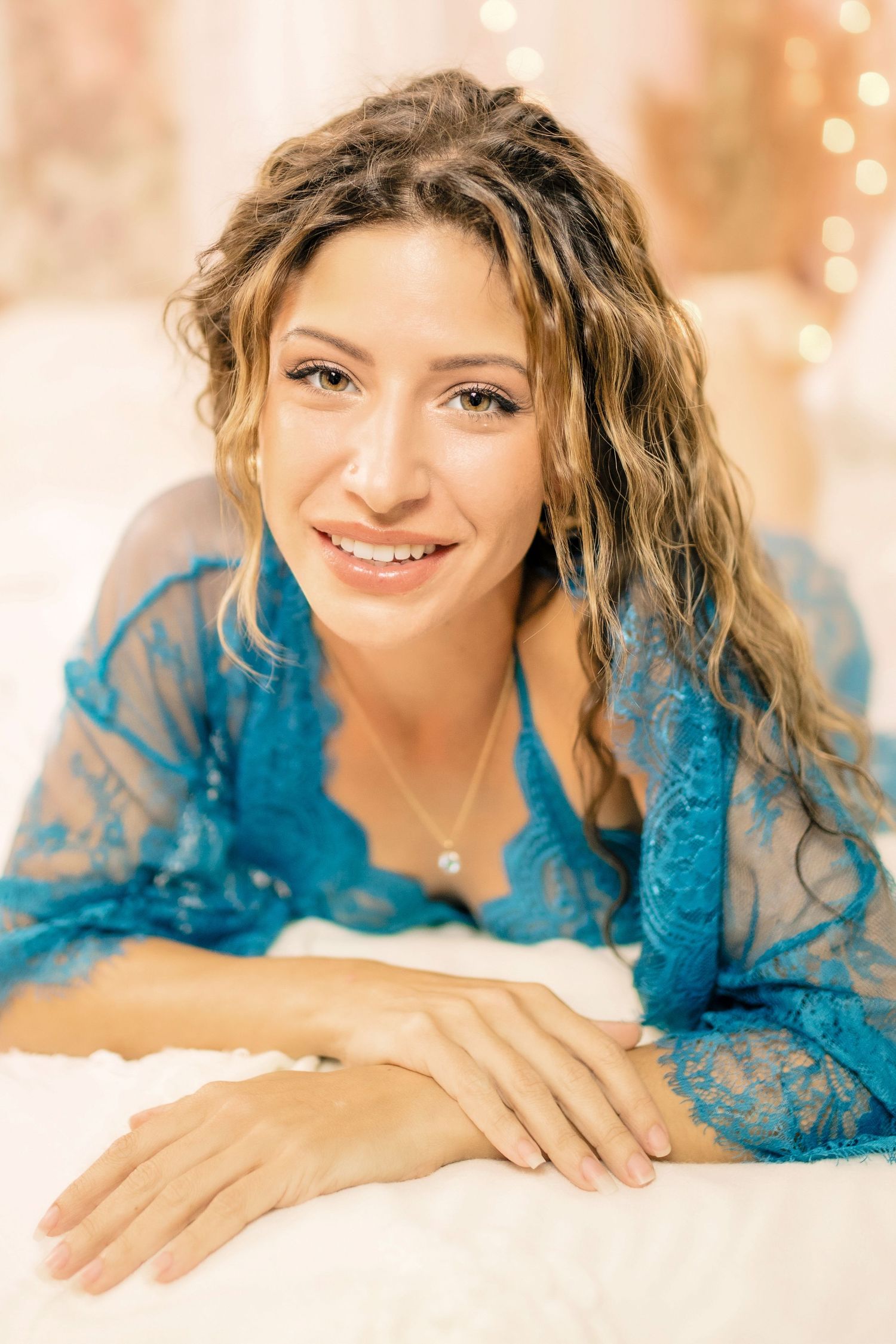 Empowering boudoir portrait of woman embracing her confidence in soft, elegant lighting.