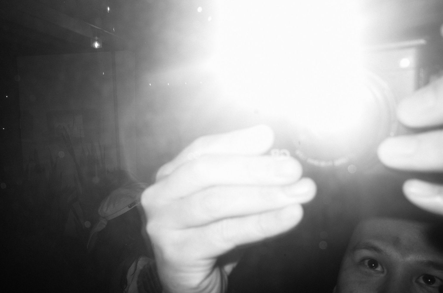Artistic blurred black and white photo with bright light flare.