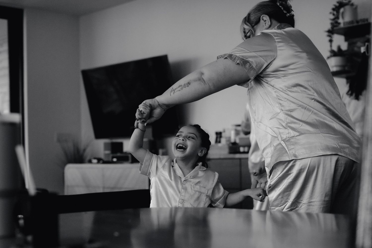A joyful moment shared between parent and child playing at home.