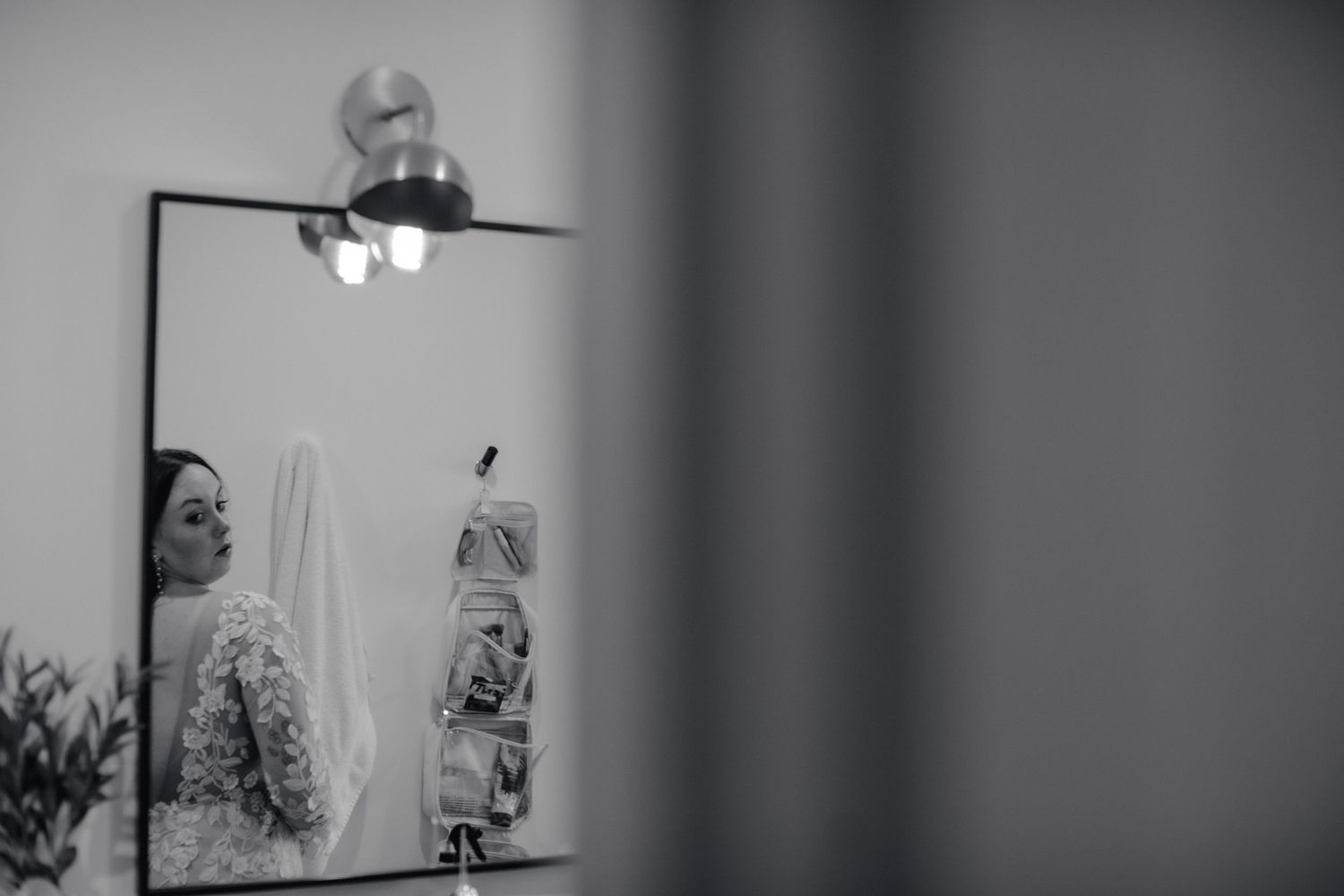 An artistic black and white photo of a lamp reflecting in a mirror.