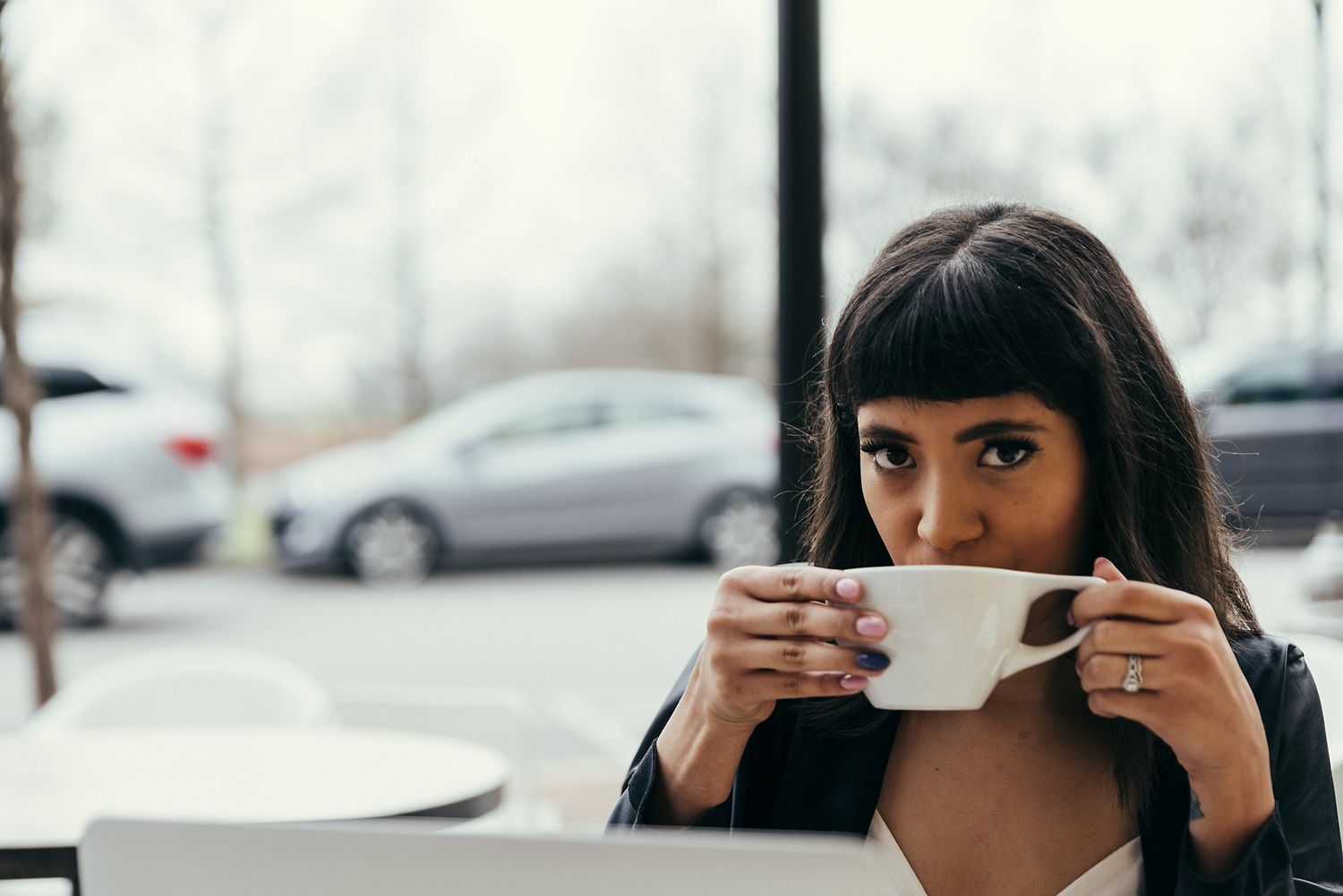 A stylish workspace scene with leather jacket and coffee mug on desk.