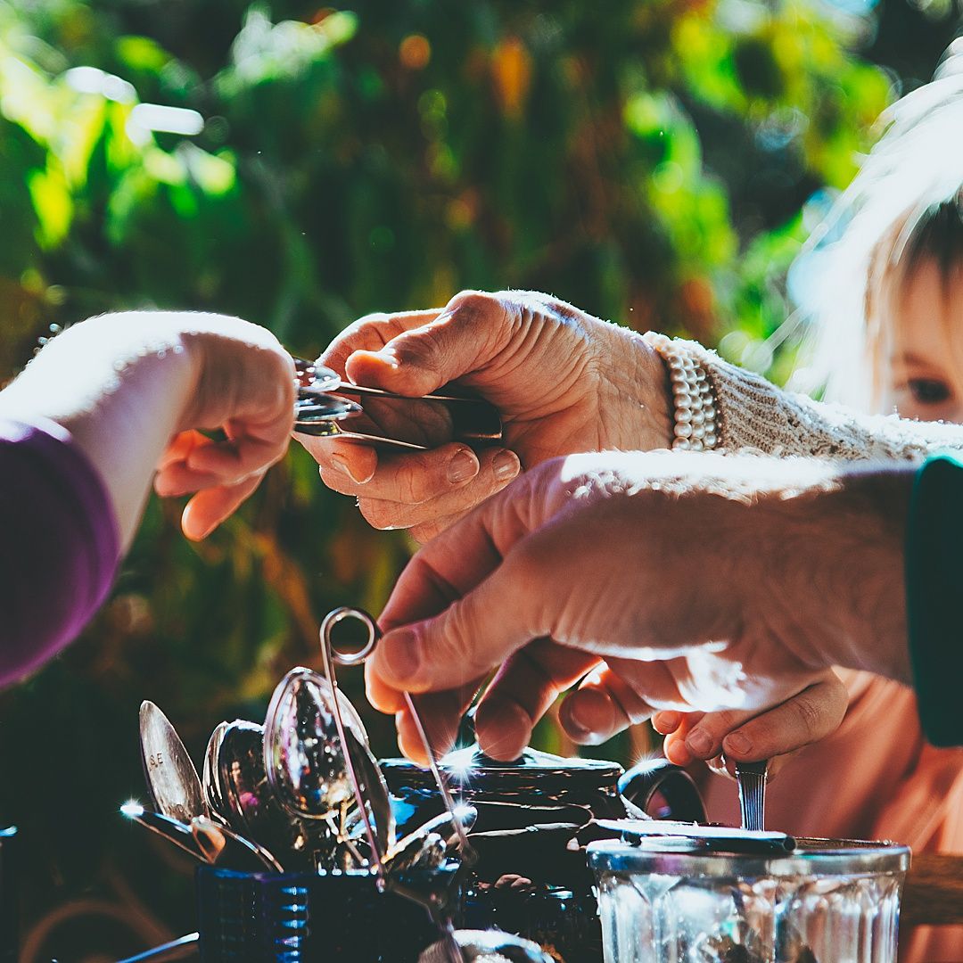 Close up of hands working on intricate mechanical parts with tools.
