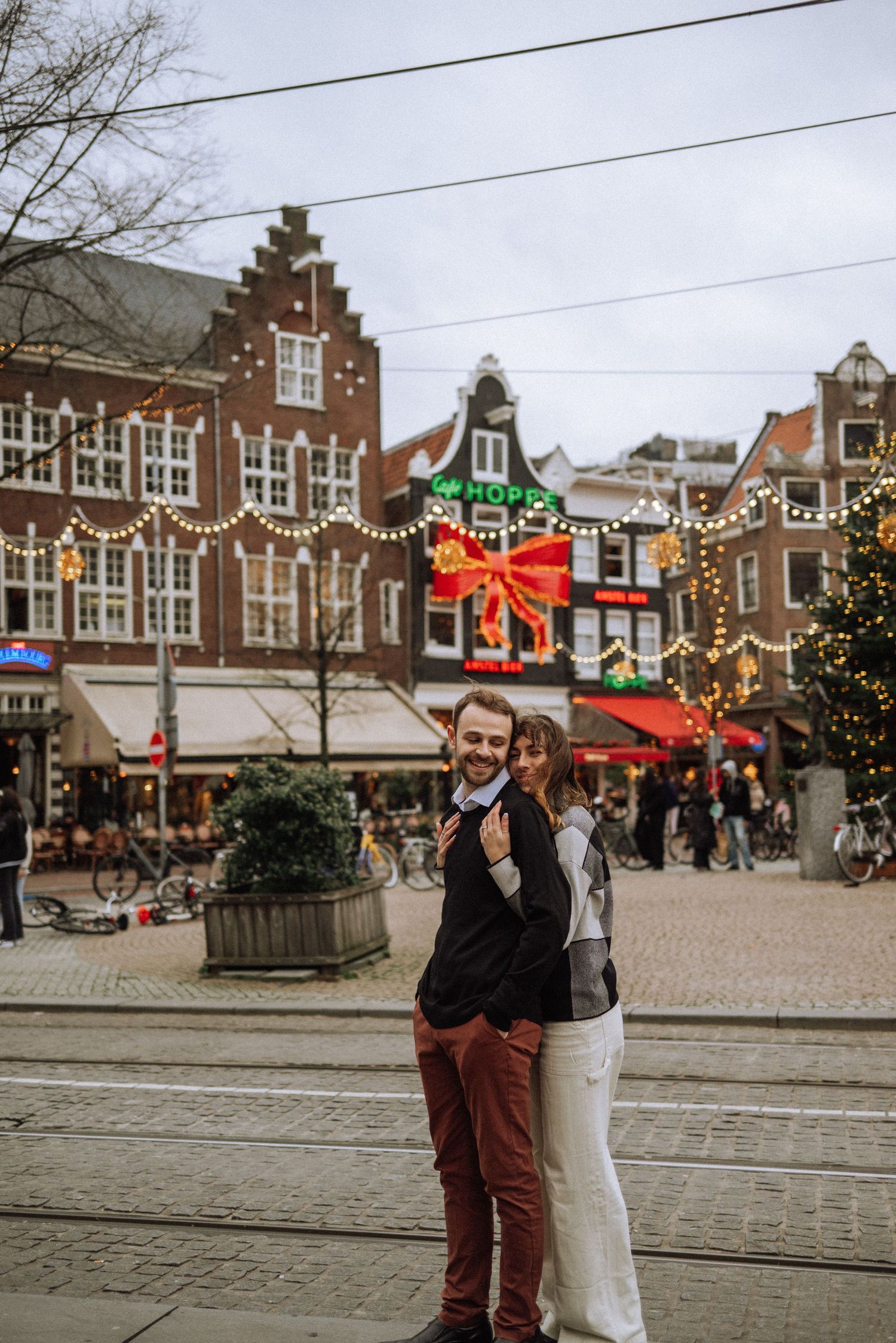 A festive Dutch town square with traditional architecture and Christmas decorations.