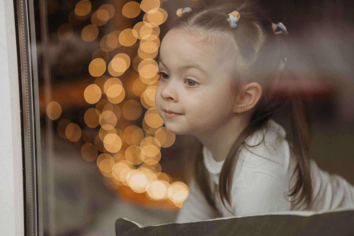 A soft bokeh background with warm glowing lights creates a dreamy atmosphere.