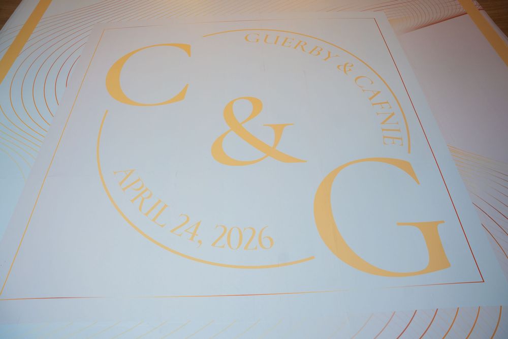 Gold monogram wedding dance floor decal with initials C&G, names Colby & Cassie, and date April 21, 2026.