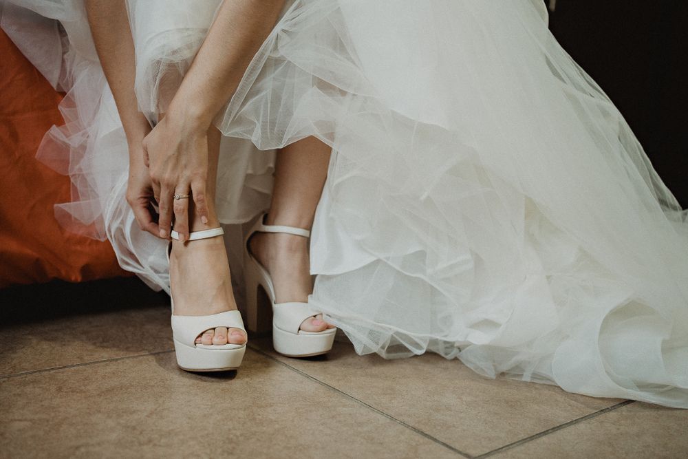 Bride putting on her wedding shoes, a personal touch to her final preparations