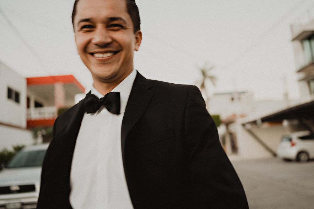 Groom walking down the street to the church, smiling and embracing the excitement of the day