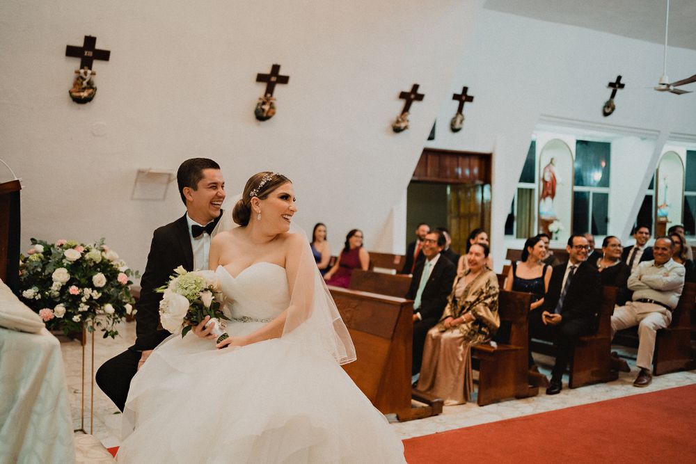 Couple looking at their guests during the religious ceremony, sharing their joy with loved ones