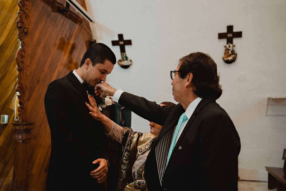Father blessing his son (the groom), a heartfelt moment of love and support during the ceremony