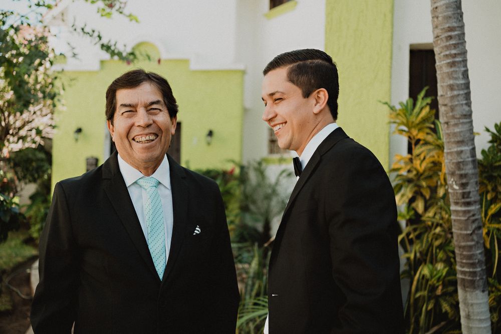 Proud father and groom sharing smiles, a heartwarming moment before the wedding ceremony