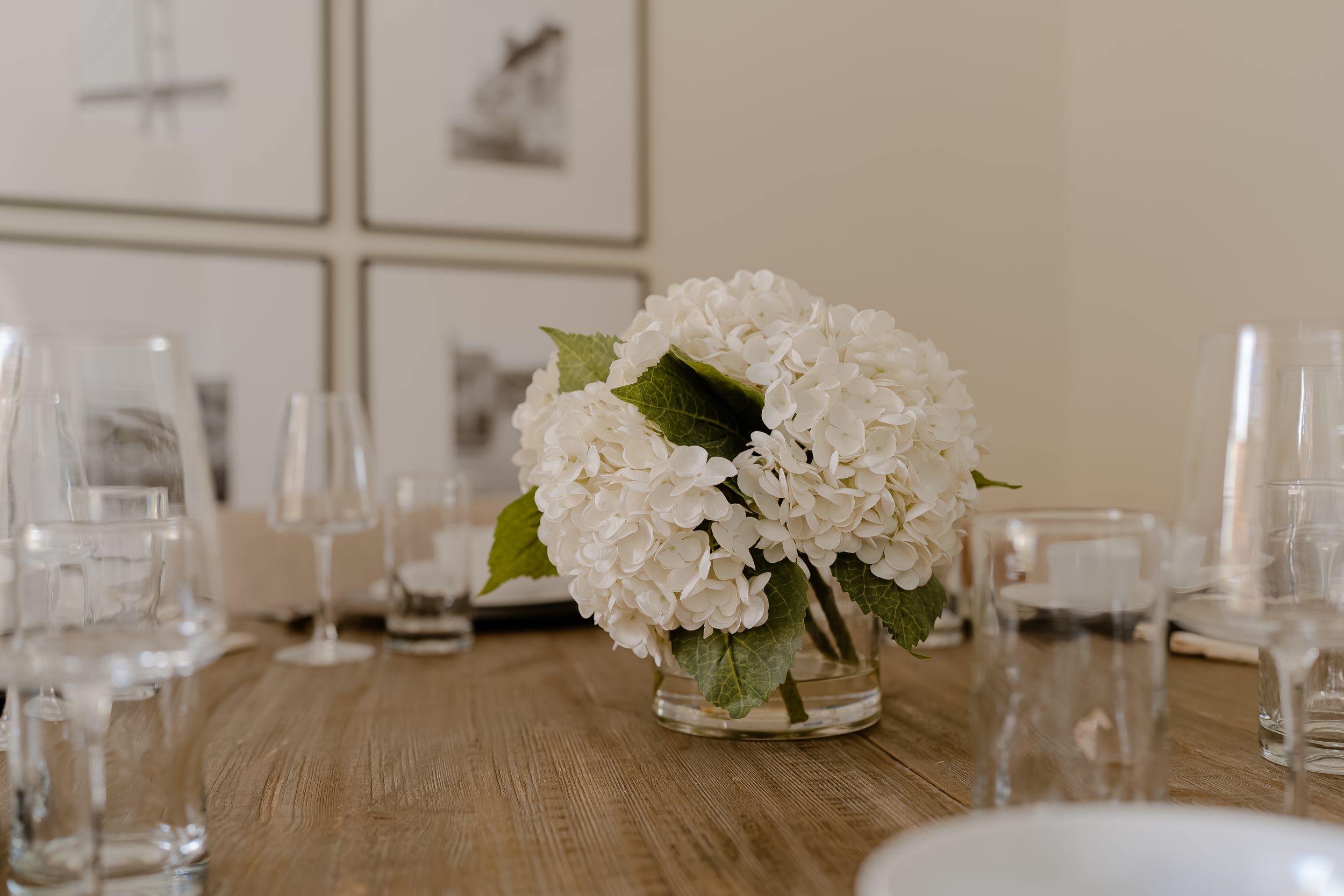 Selective focus photograph of greenery and dried flowers in a decorative arrangement against a blurred background.