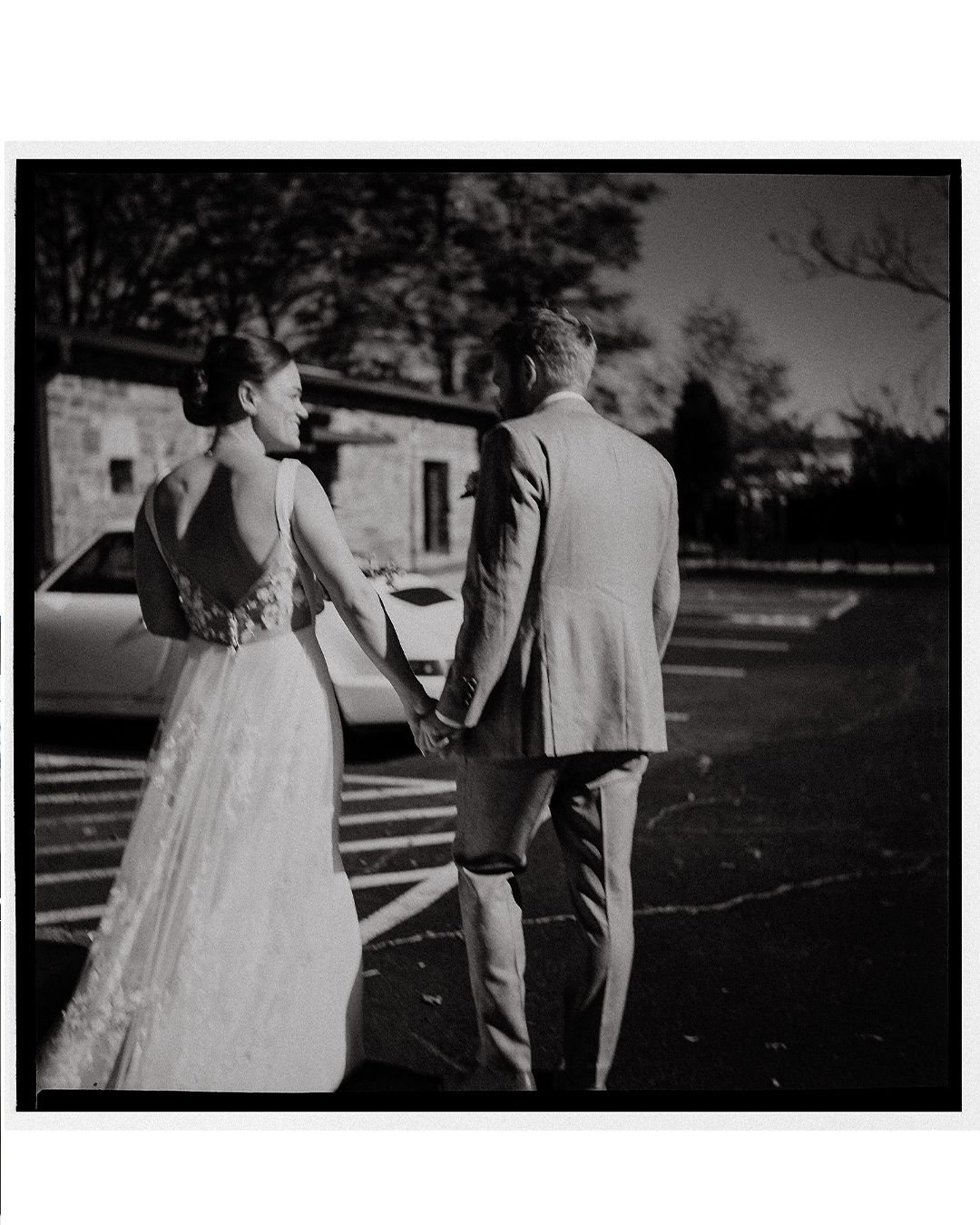 Black and white wedding photos showing a couple in formal attire walking together outdoors.