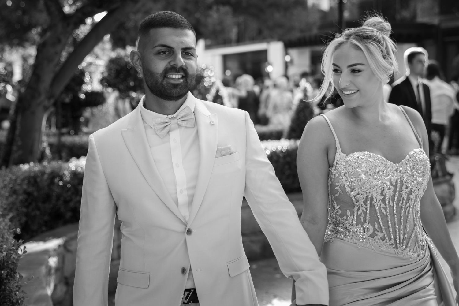 Elegant black and white wedding portrait of a couple during their outdoor ceremony.