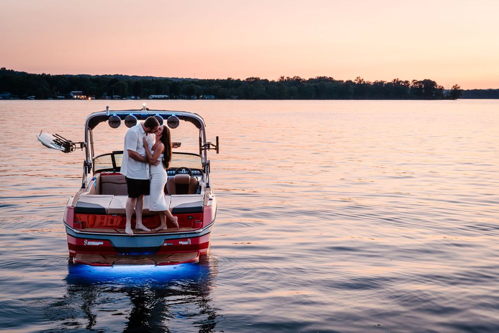 A romantic sunset boat ride on calm waters with pink and orange sky.