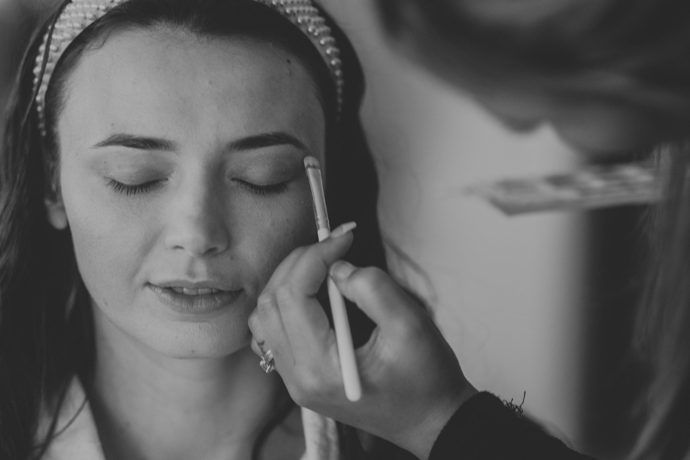 Romantic black and white photo series of a couple sharing intimate moments during a wedding celebration.