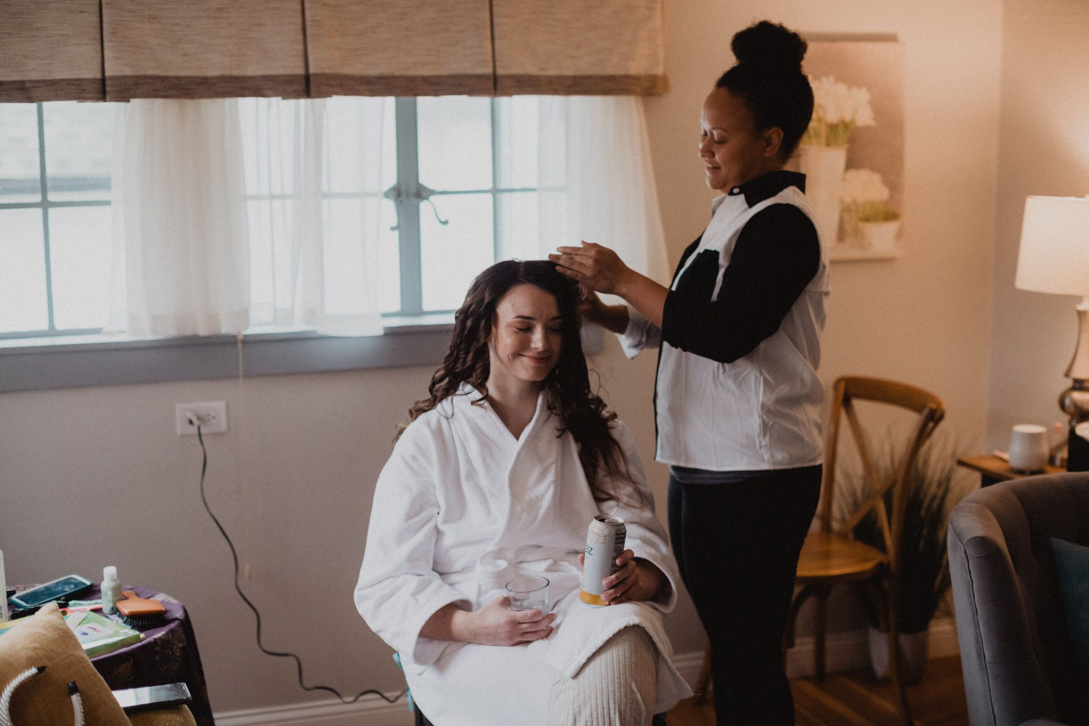 Elegant wedding dress preparations in a naturally lit room with soft morning light.