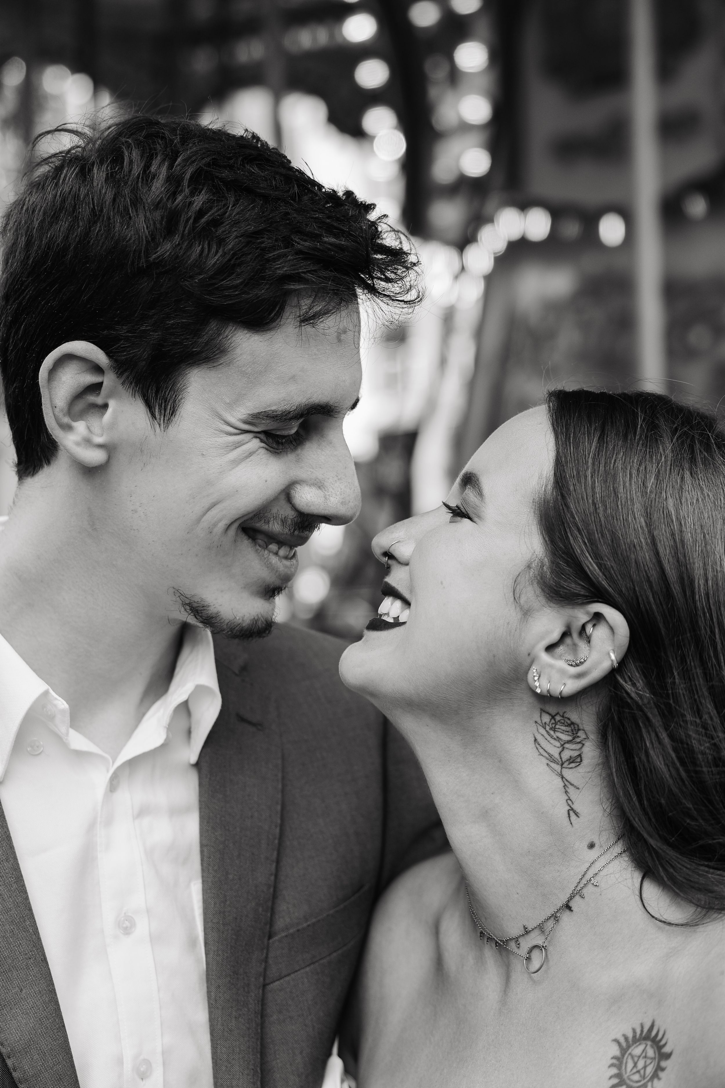 Black and white close-up of laughing couple sharing a joyful intimate moment together.