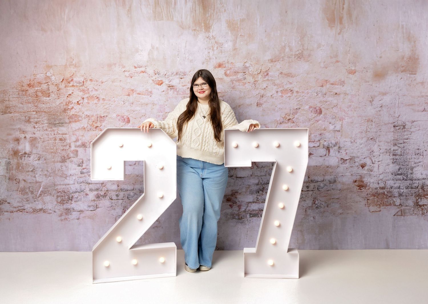 High school senior studio portrait with illuminated number props, photographed by a New Hampshire senior photographer in the Lakes Region
