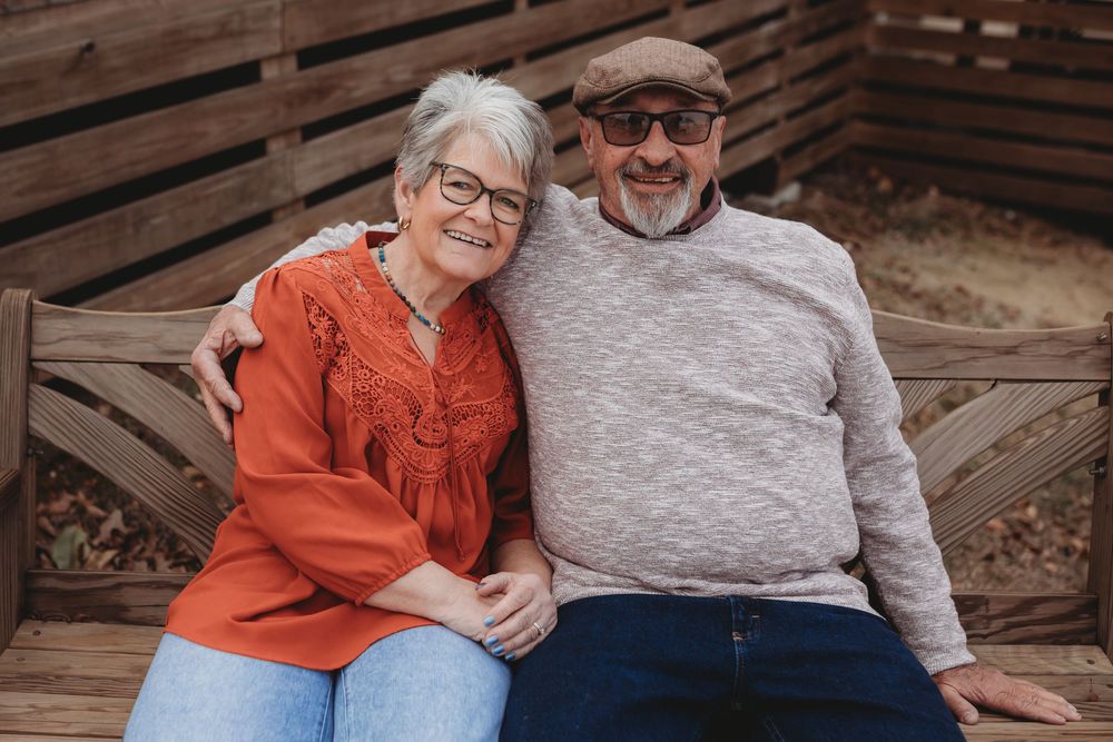A couple in casual attire sits together on wooden steps sharing affectionate moments in multiple poses.