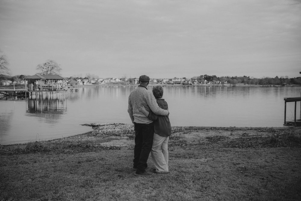 A black and white photo series showing a tranquil lakeside scene with silhouettes against a misty waterfront landscape.