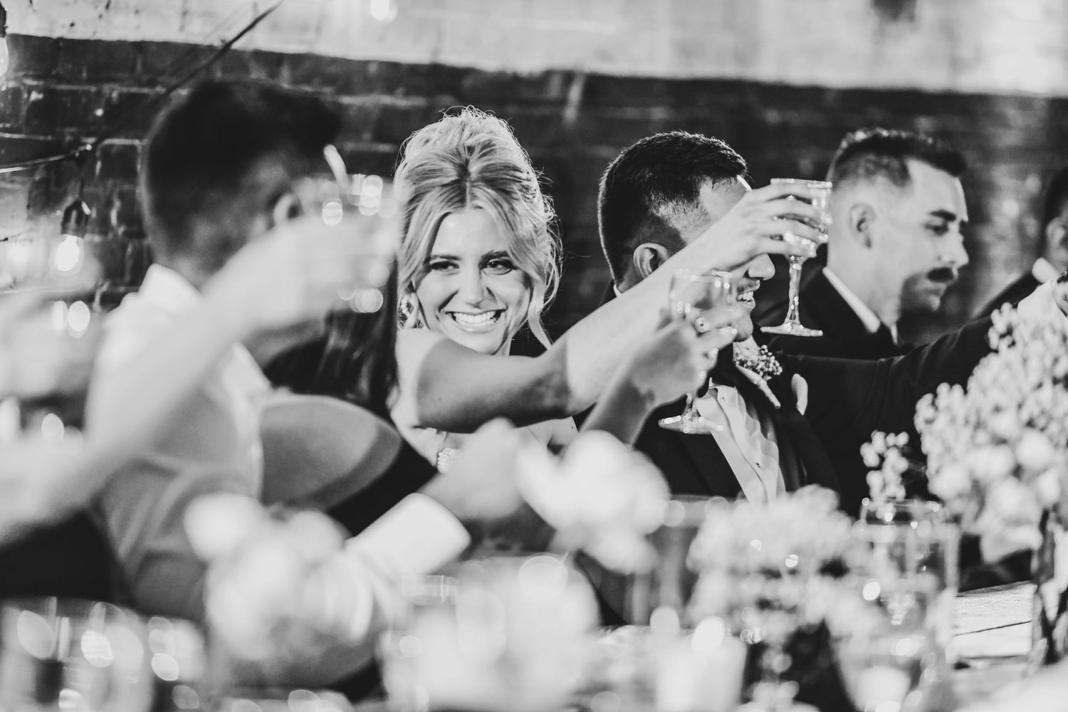 Guests raising glasses during heartfelt wedding toasts