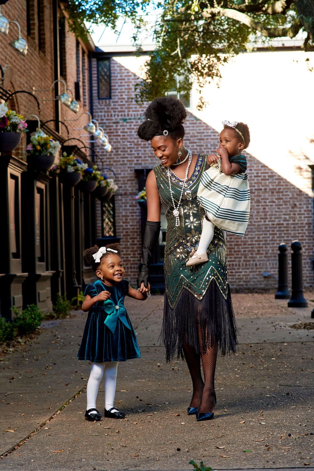 Mother with two little kids outdoor photoshoot for green christmas themed shoot
