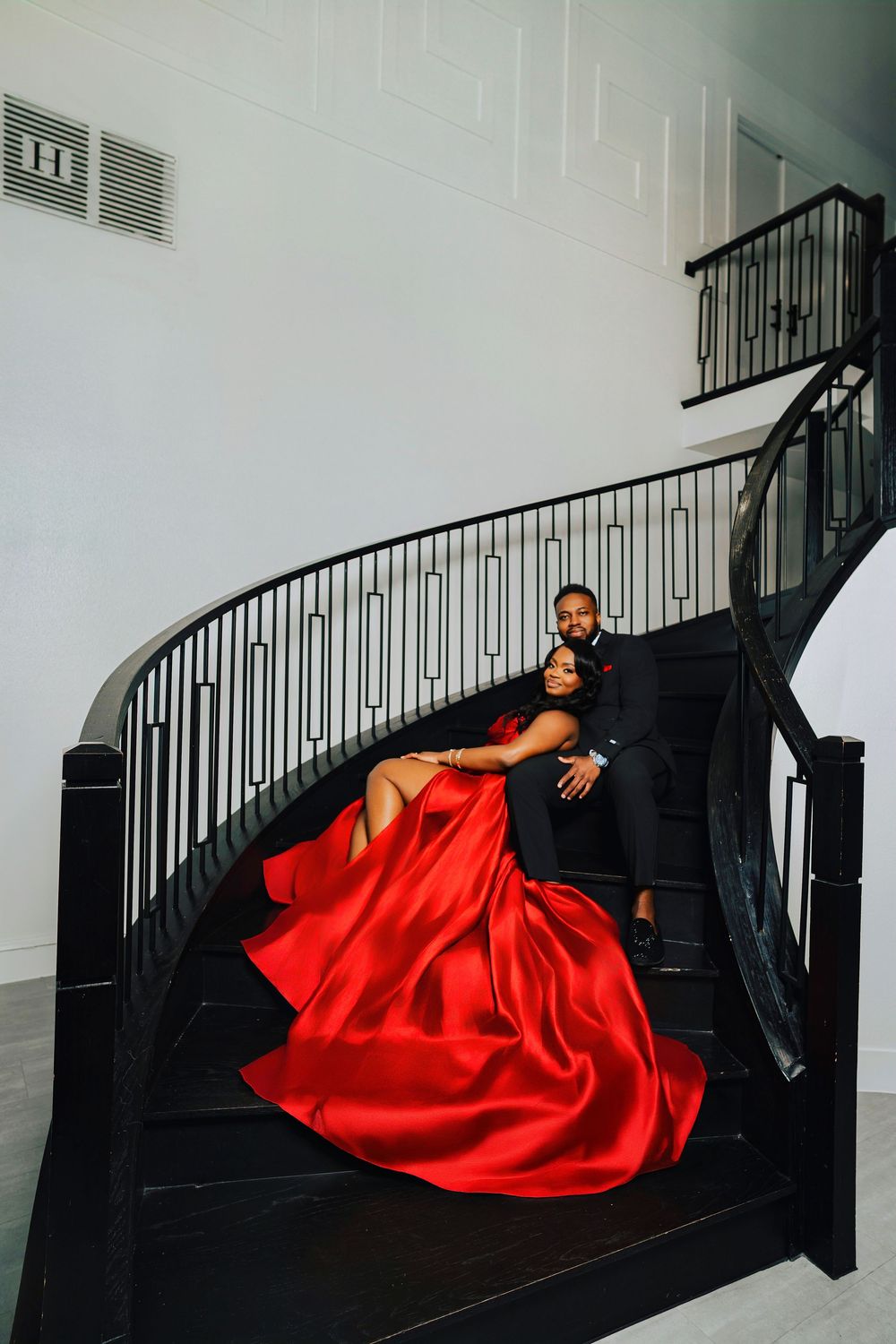 Dramatic photo series showing a person in black against stairs with flowing red fabric creating elegant contrast.