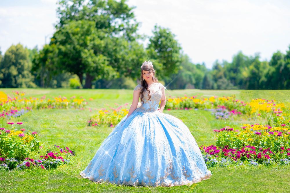 Ethereal blue ballgown dress photographed in blooming flower garden.