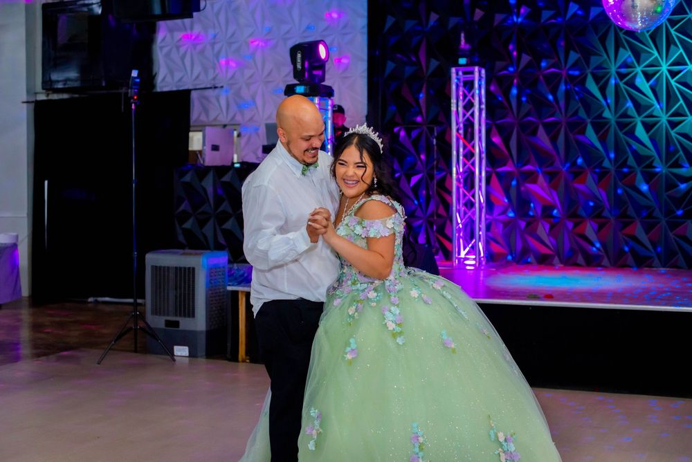 A special dance moment captured at a quinceañera celebration with mint green ball gown.