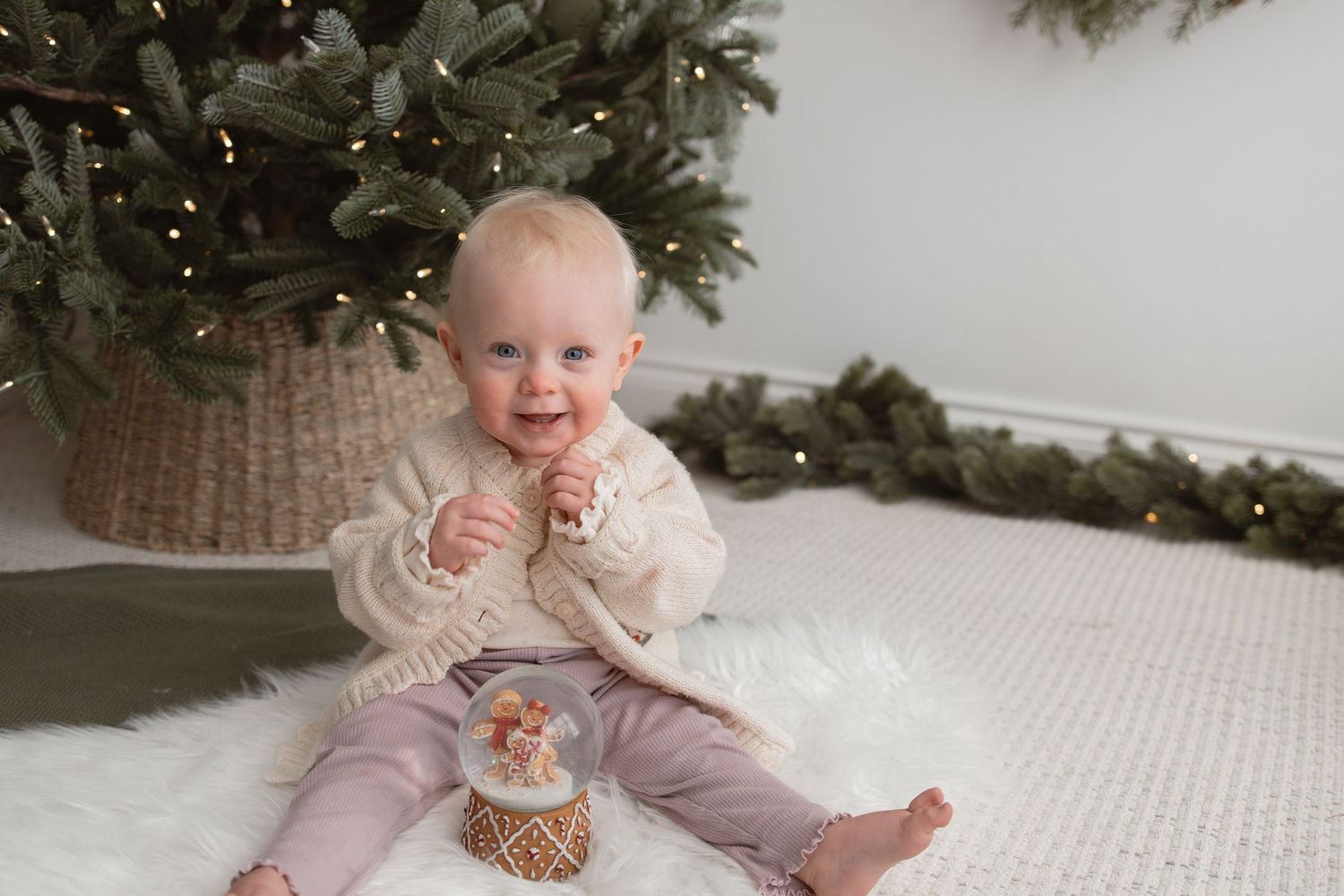 Holiday portraits featuring joyful expressions near a decorated Christmas tree with twinkling lights. Photography in Buckinghamshire.