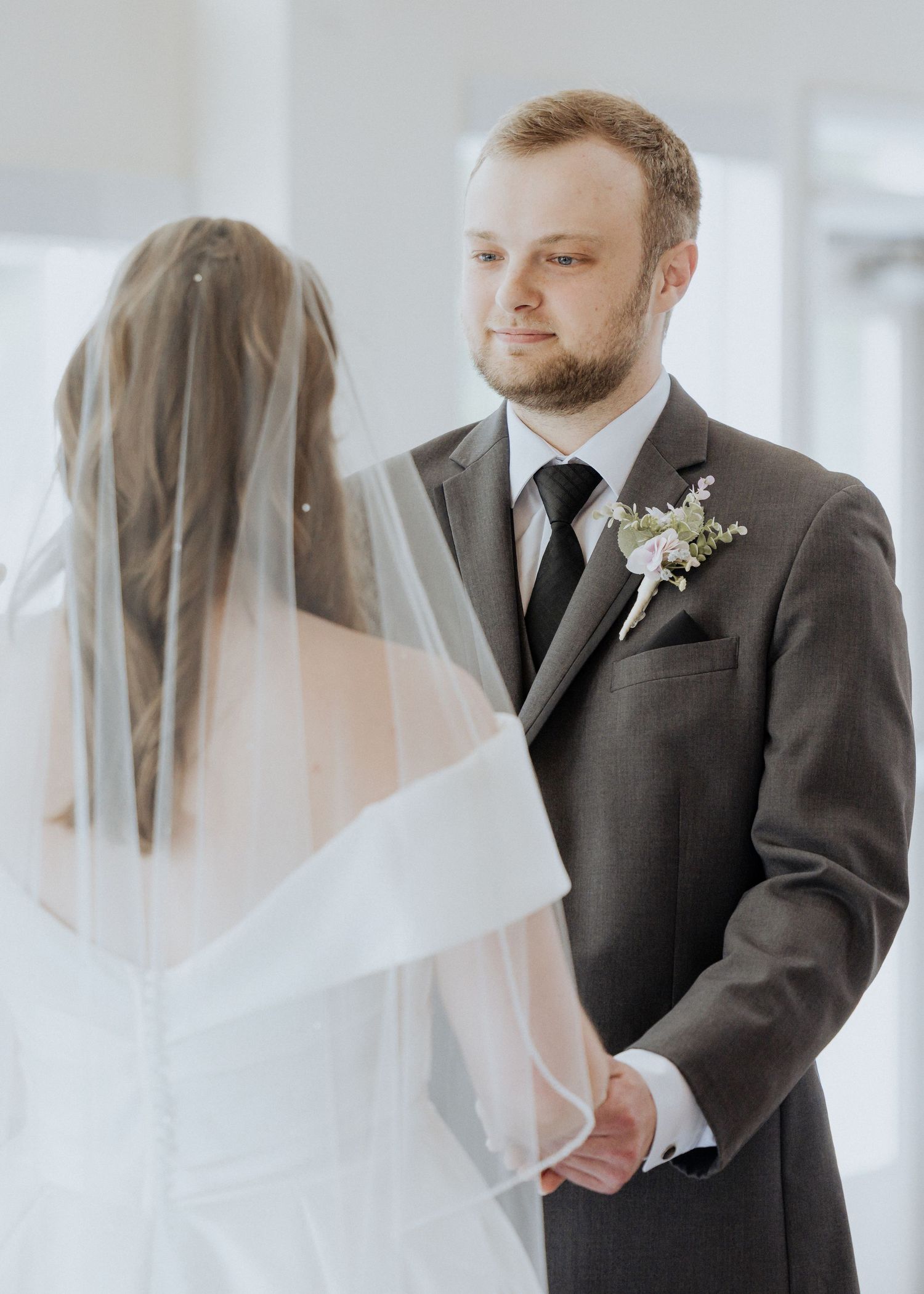 bride and groom hold hands while exchanging vows, indoor summer wedding in New Brunswick, photography package with two photographers in NB