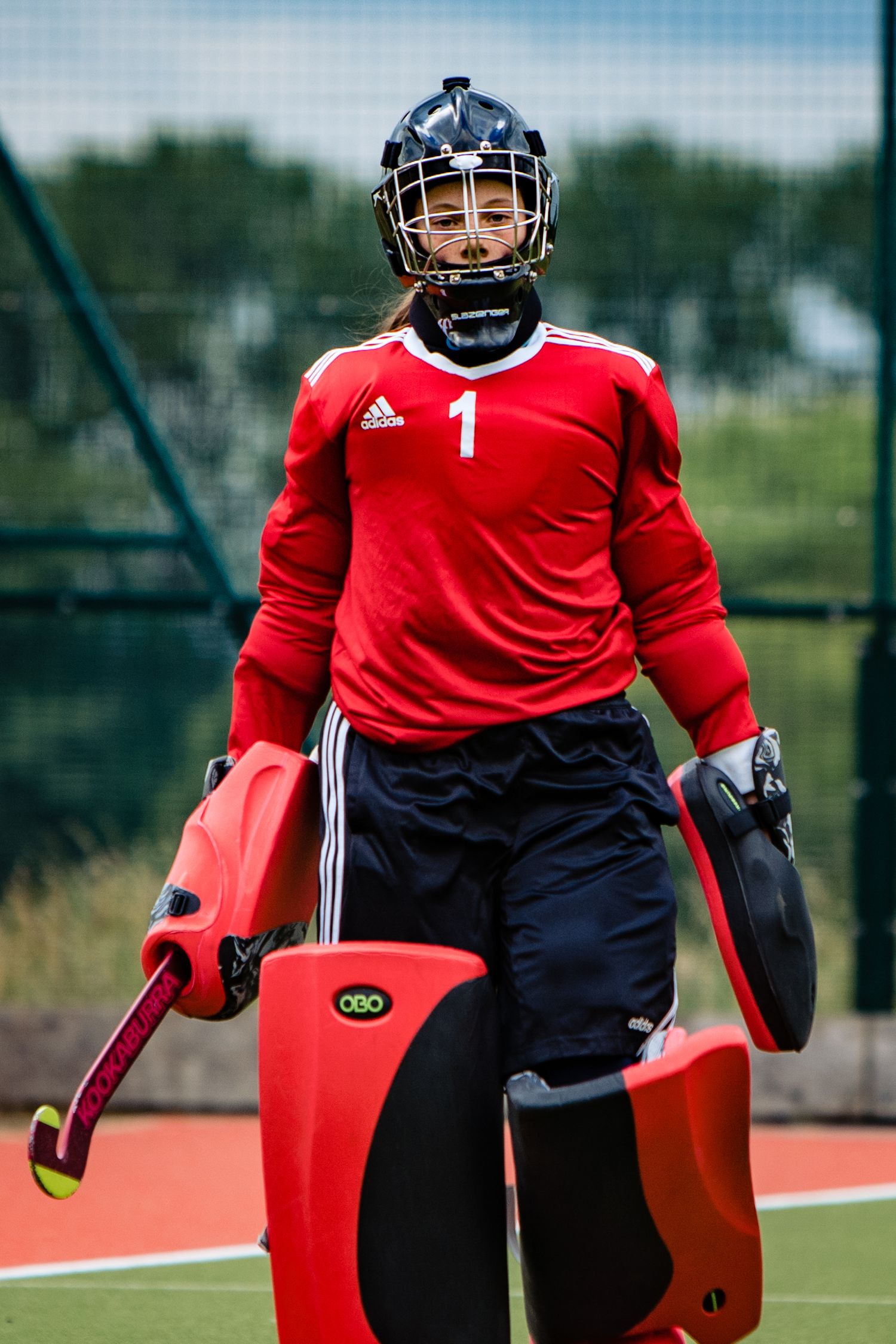 Professional sports photographer in Gloucestershire capturing female hockey goalkeeper in full kit