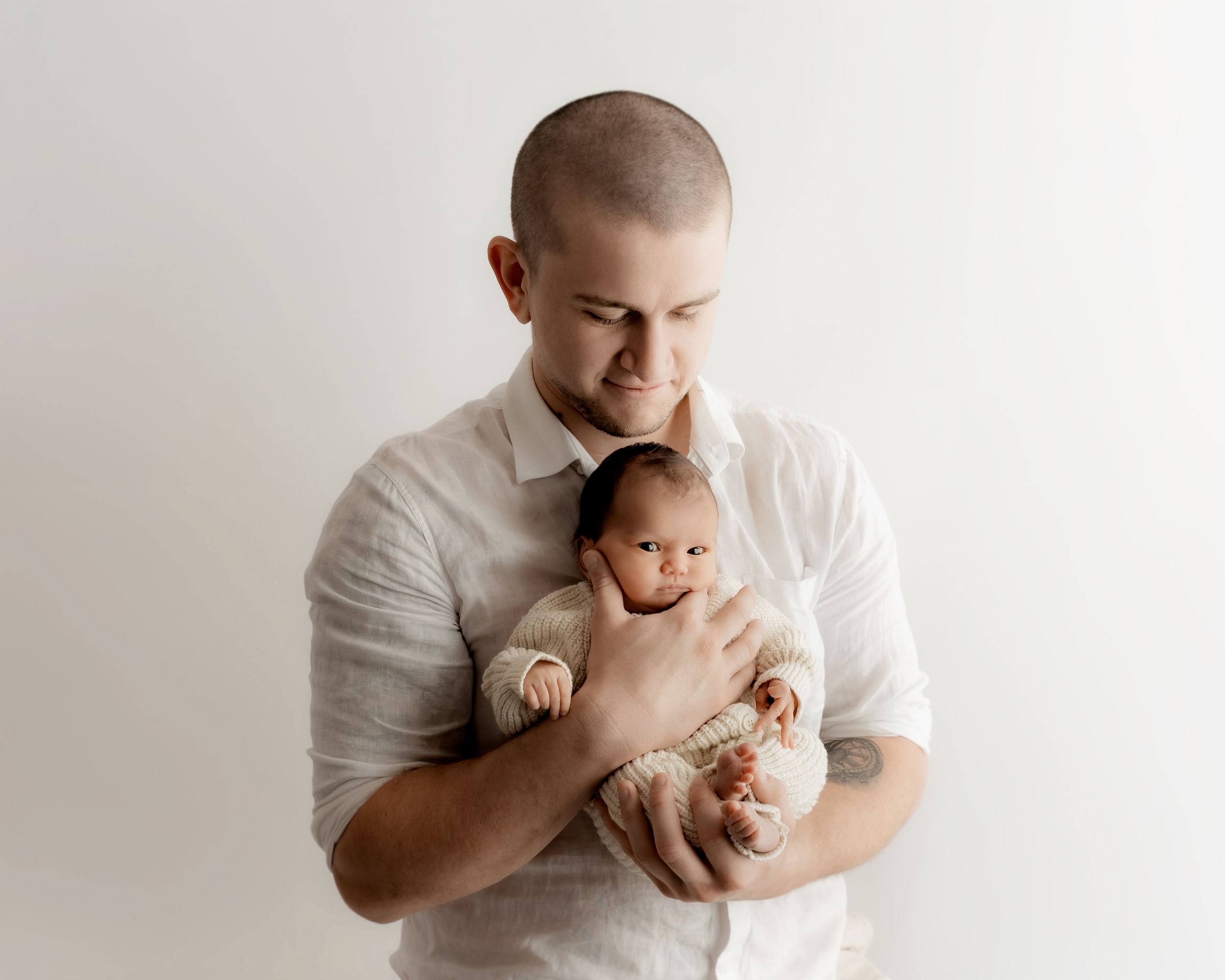 Father holding newborn baby during family photography session