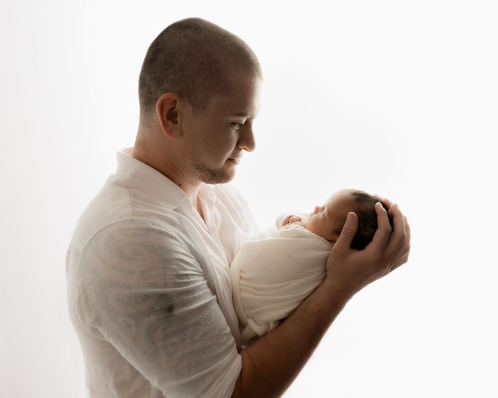 Father admiring his newborn baby