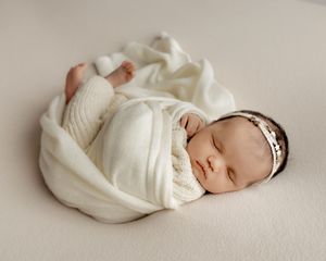 Newborn baby photographed in soft natural light