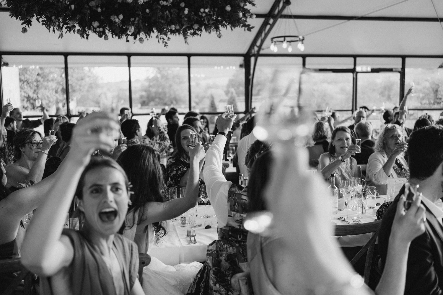 Guests laughing during speeches at a relaxed Sudeley Castle wedding