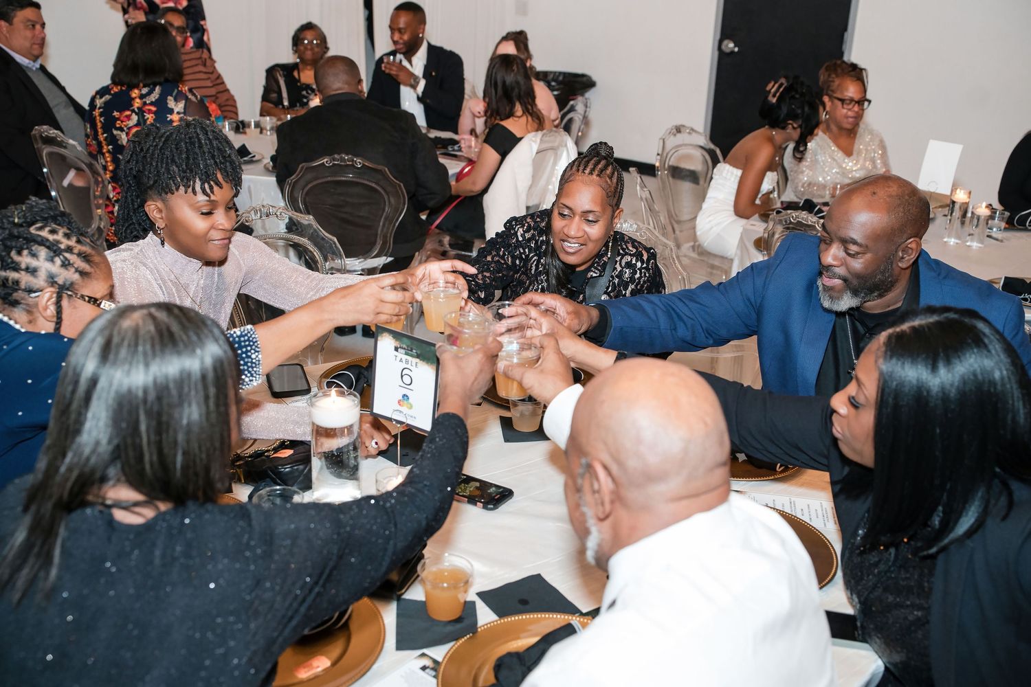 Group of people enjoying a lively social gathering at an indoor party.
